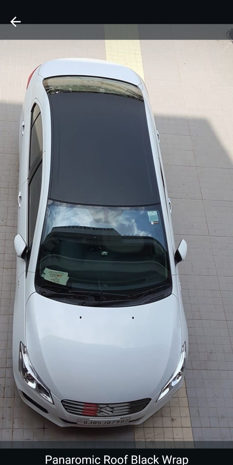 Car with panoramic black roof wrap applied